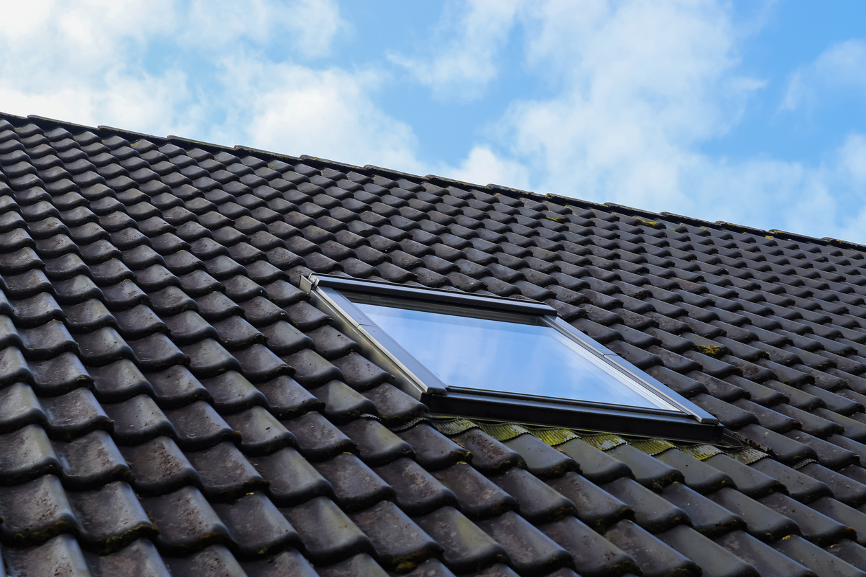 Roof Window in Velux Style with Black Roof Tiles.